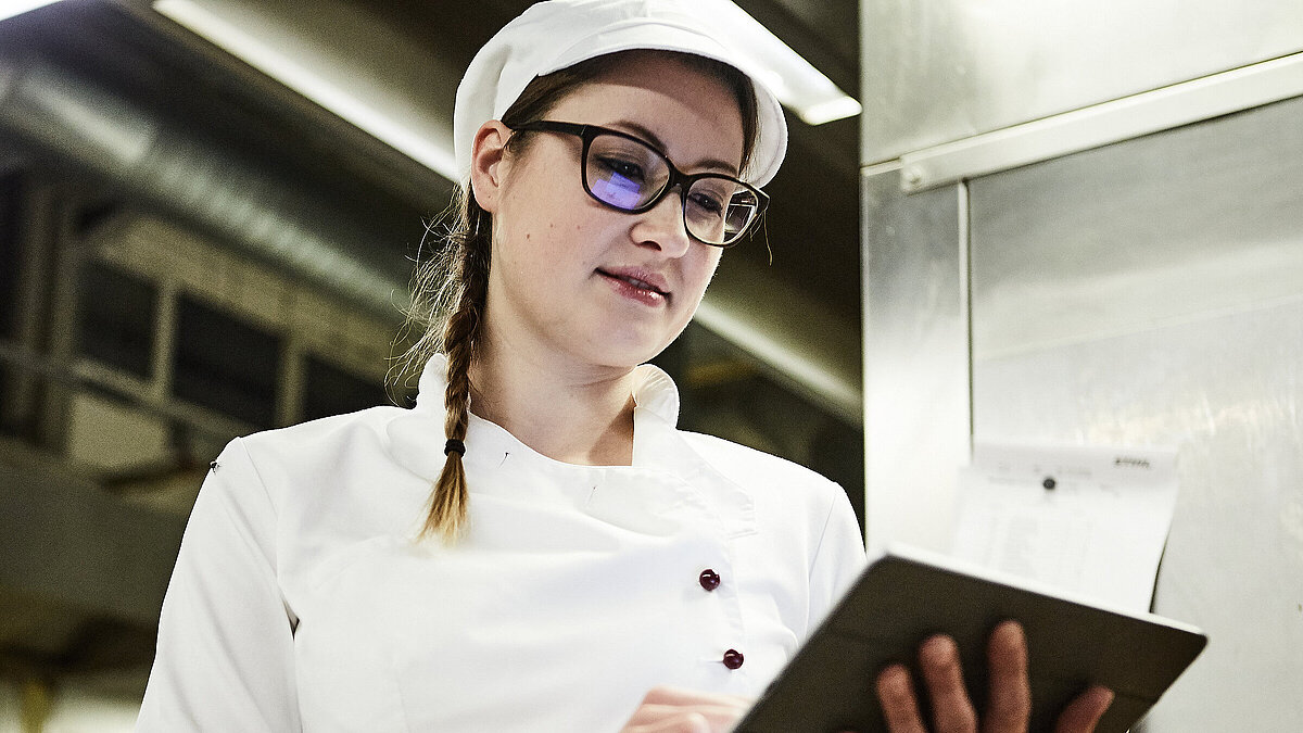 Bäckerin schreibt was auf ein Klemmbrett