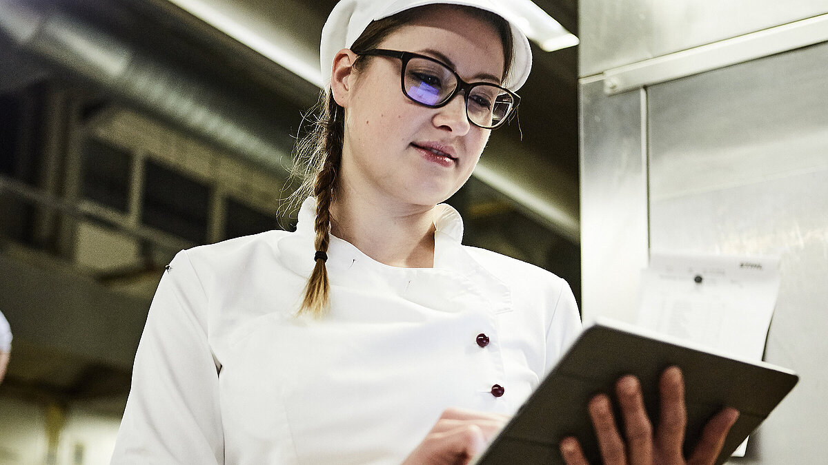 Bäckerin schreibt was auf ein Klemmbrett